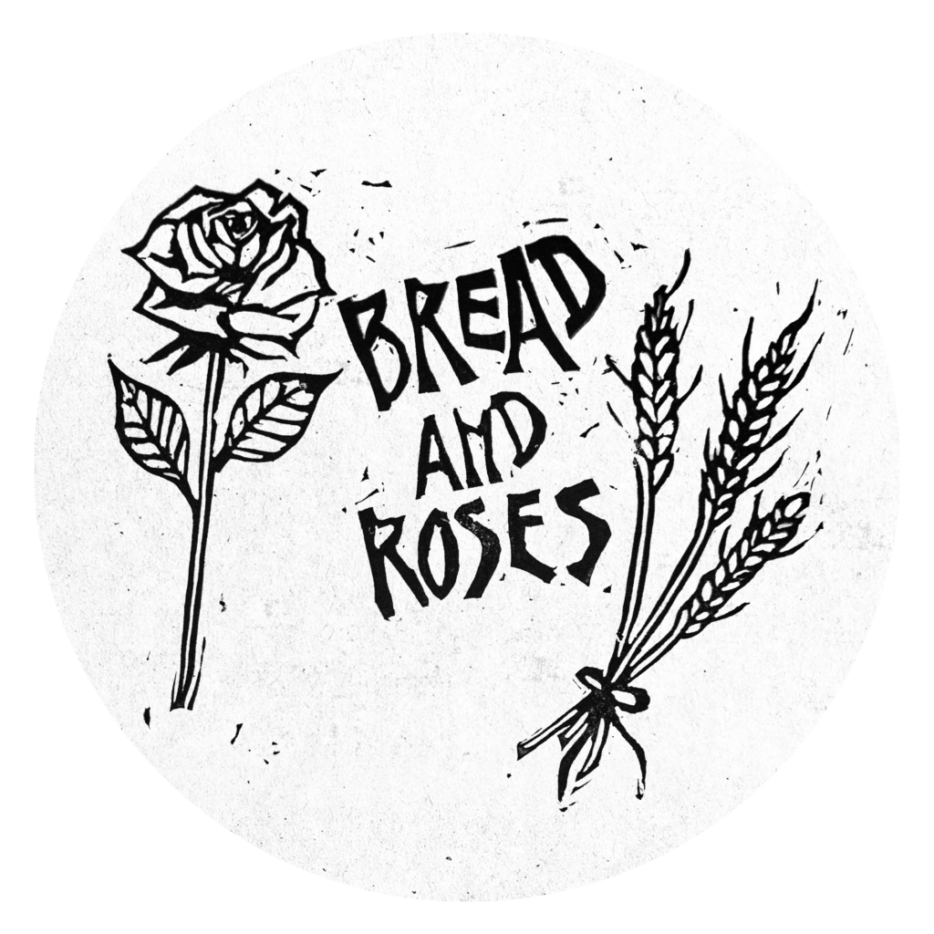 Black and white print of a rose and some wheat stalks and the words: "Bread and roses."